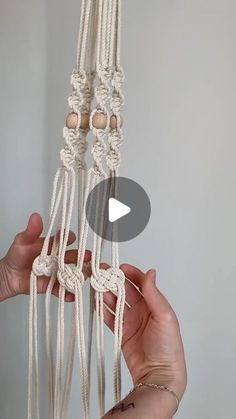 someone is holding up some white macrame