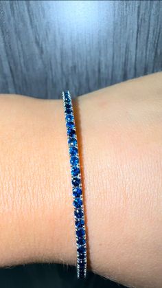 Born in September? This Bracelet says your name on it. The natural blue charm this gorgeous Blue Sapphire Tennis Bracelet will surely turn heads. This Bracelet is so easy to stack or wear on its own. Manufactured in Los Angeles using The Highest-Quality Gold and Gemstones. Material: Solid Gold Natural Blue Sapphires: Round Cut, Prong Set *These are 100% Natural Gemstones Please Note: All our bracelets come in a standard size of 7 Inches, the carat weight on this bracelet is based on that size. We carry various sizes and selections, feel free to reach out for the specific variation you are looking for. Sapphire Tennis Bracelet, Born In September, Blue Charm, Wedding Jewelry Bracelets, Natural Blue Sapphire, Tennis Bracelet, Wedding Bracelet, Your Name, Prong Setting