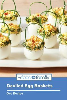 deviled egg baskets on a white plate with green sprouts and yellow flowers