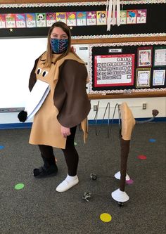 a woman in a dog costume holding a piece of paper while standing next to a horse