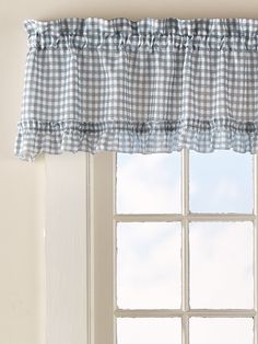 a window with a blue and white checkered valance