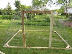 an outdoor chicken coop in the grass