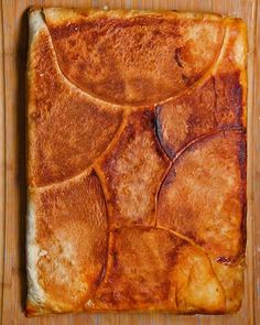 a square shaped food item on a wooden surface