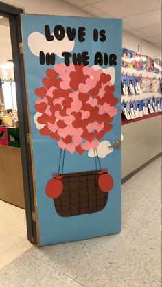 a door decorated with hearts and the words love is in the air