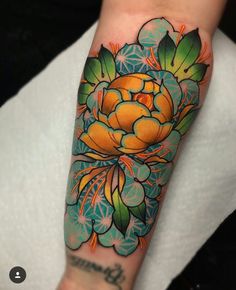 a colorful flower tattoo on the arm