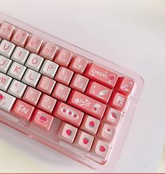 a pink and white computer keyboard with hearts on it's backlit keyset