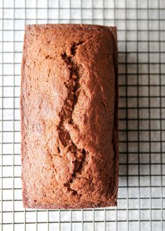 a close up of a loaf of bread on a cooling rack