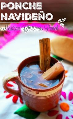 a cup filled with hot chocolate and cinnamon sticks