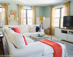 a living room filled with furniture and a flat screen tv