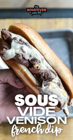 a person holding a sandwich in their hand with the words sous venison french dip on it