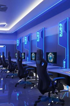 a room filled with lots of computer monitors and chairs