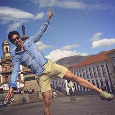 a man standing on one leg in the air with his legs spread out and arms outstretched