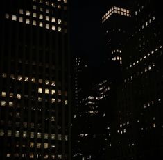 some very tall buildings lit up at night