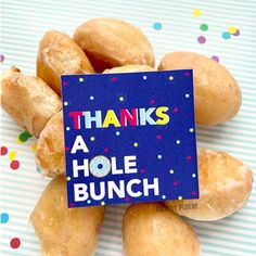 a pile of doughnuts with a sign that says, thanks a hole bunch