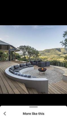 an outdoor living area with couches and fire pit