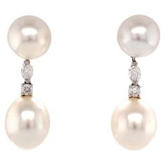 RARE. OVAL SHAPE AAAA TOP QUALITY PEARLS. A pair of drop earrings that each comprise two round and cream body color South Sea pearls, that each measure approximately 12.7 x 15.60mm. Each earring is punctuated by a marquise shape diamond and a round cut diamond. The diamonds total approximately 1.40 carats and exhibit approximately G color and VS1-VS2 clarity. Platinum and 18K White Gold. Approximate Total Gross Weight: 15.48 Grams. 1 7/8 x 1/2 Inches. New. We have been designing and making jewel Marquise Shape Diamond, Cream Body, Sea Pearl, South Sea Pearls, Sea Pearls, Women Diamond, Diamond Drops, Body Color, Pearl Diamond