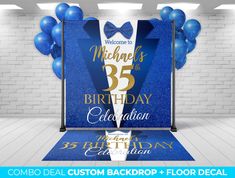 a blue carpet with balloons and bow tie on it for a birthday party or celebration