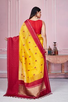 Radiate elegance on special occasions in this yellow Banarasi saree with red border and zari pallu. It comes with a blouse piece. Disclaimer: The shown stitched blouse on the model is for display purpose only. The saree comes with a matching blouse piece and finished with fall and piko. Yellow Semi-stitched Handloom Saree, Yellow Slub Silk Traditional Wear With Resham Embroidery, Traditional Yellow Slub Silk Wear With Resham Embroidery, Yellow Traditional Wear With Resham Embroidery In Slub Silk, Yellow Handloom Pre-draped Saree For Wedding, Yellow Handloom Pre-draped Saree For Navratri, Yellow Tussar Silk Pre-draped Saree For Diwali, Yellow Chanderi Sets With Embroidered Border, Yellow Pre-draped Saree With Resham Embroidery For Transitional Seasons