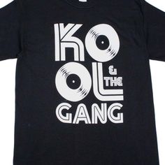 Kool & The Gang Records Logo Rap Hip Hop Throwback Retro Rock N Roll Concert Short Sleeve Tee Shirt. Adult Size Shirt Made From 100% Pre-Shrunk Medium Weight Cotton. Every Item We Sell Is Original Brand New. If An Item Is Designated As "Distressed", The Design Contains Intentional Skips And Voids Which Give The Item A Worn-In Or Vintage Look. These Are Part Of The Actual Design And Do Not Reflect Poor Printing. Rock N Roll Concert, What Boys Like, Vintage Look, Rock N Roll, Black Tshirt, Breathable Fabric, Rap, Black Color, Short Sleeve Tee