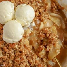 an apple crisp with three scoops of ice cream on top, in a bowl