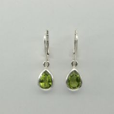 These is a pair of beautiful Earrings with Peridot. The earrings are made out of solid 925 Silver and there is no nickel or other substances causing most allergies. This makes the earrings hypo allergenic. Size of one Earring in total 3.0 x 0.8 cm or 1.18 x 0.31 inch The hooks are about 1.8 - or a bit less than 3/4 inch - in length. You will receive the item in a gift box - perfect to surprise someone or yourself. Usually we ship on the same day we receive the payment for the order. We want you Peridot Earrings Silver, Simple Sage Green Earrings, Green And Silver Earrings, Formal Green Sterling Silver Teardrop Earrings, Formal Green Teardrop Sterling Silver Earrings, Green Sterling Silver Teardrop Earrings For Formal Occasions, Sterling Silver Teardrop Pear Earrings For Anniversary, Teardrop Earrings With Bail As Gift, Sterling Silver Teardrop Jewelry With Bail