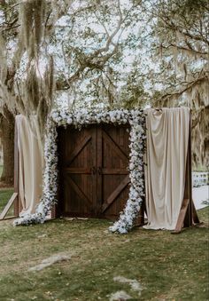 Ceremony doors | wedding ceremony doors | barn doors | wedding ceremony decor | wedding ceremony flowers | wedding ceremony elegant decor | wedding ceremony door entrance | champagne wedding colors | neutral wedding | southern wedding | outdoor ceremony | outdoor ceremony inspo | elegant wedding decor | outdoor wedding | outdoor ceremony decorations | ceremony floral inspo | elegant wedding floral | ceremony flowers | wood doors | wooden doors | barn doors | custom wood doors Wedding Doors Outside, Rustic Wedding Altar Outdoor Ceremony, Wedding Door Entrance Outside, Rustic Door Wedding Entrance, Wedding Ceremony Seating Decor, Door Arch Wedding, Outdoor Ceremony Entrance, Wedding Barn Door, Wooden Wedding Doors