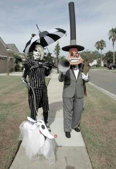 two people in halloween costumes are walking down the sidewalk