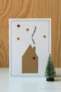 a christmas card with a small tree on top of it and the words happy new year written