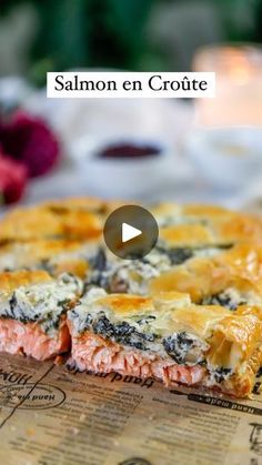 salmon en croute on a cutting board with flowers in the background