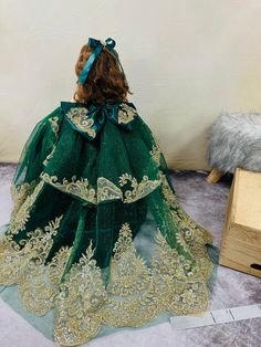 This custom BELL DOLL is fit for a princess' quinceañera. Featuring a hunter green tulle skirt with glitter gold accents and a French aplique, this doll is the perfect addition to any collection. Princess Style Green Ball Gown For Pageant, Green Princess Dress For Pageant, Green Princess Dress For Pageants, Green Princess Gown For Pageant, Green Princess Gown For Pageants, Princess Style Green Gown For Pageant, Green Princess Style Pageant Dress, Green Ball Gown Pageant Dress For Wedding, Green Ball Gown For Wedding Pageant