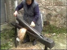 a woman is holding two large pieces of wood