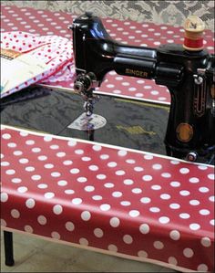 a sewing machine sitting on top of a table covered in polka dotty cloths