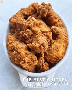 fried chicken in a white bowl with the words the best chicken tenders ever written on it