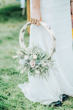 a close up of a person holding a wedding ring