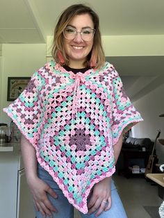 This super soft poncho is perfect for the changing seasons. Made with acrylic yarn, it will keep you cozy and warm. It has a drawstring adjustable neck. Casual Oversized Acrylic Poncho, Cozy Pink Poncho For Fall, Oversized Acrylic Poncho In Casual Style, Cozy Acrylic Poncho, Cozy One Size Poncho For Beach, Casual One Size Acrylic Poncho, Cozy Pink One Size Poncho, Casual Pink Poncho For Fall, Casual Crochet Poncho For Spring