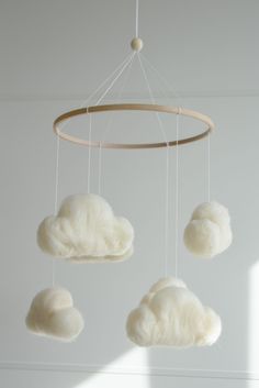 a white cloud mobile hanging from a ceiling