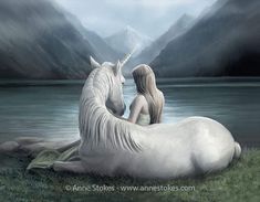 a woman sitting on top of a white unicorn next to a lake