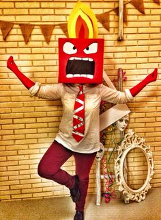 a woman is dressed up as a hot dog in front of a brick wall with buntings