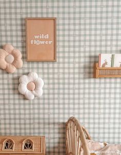 a baby's room with green and white checkered wallpaper, wooden rocking chair and toy dresser