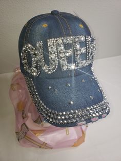 Finish your look with this fabulous Queen Rhinestone Hat that provides a touch of personality and is especially great for that bad hair day. Denim rhinestone one size fits most 100% Cotton Trendy Rhinestone Adjustable Baseball Cap, Trendy Rhinestone Snapback Baseball Cap, Trendy Snapback Baseball Cap With Rhinestones, Adjustable Rhinestone Baseball Cap For Party, Trendy Summer Hats With Rhinestones, Casual Rhinestone Hat, One Size, Casual Rhinestone Hat, One Size Fits Most, Adjustable Baseball Cap With Bling, Trendy Rhinestone Baseball Cap