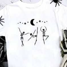 two skeletons dancing in front of the moon and stars on a white t - shirt