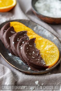 orange slices dipped in chocolate on a plate