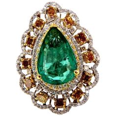 Green Pear Allure. 8.63ct. Natural GIA Certified Emerald Ring GIA Certified Report ID: 5161616364 18.78 X 12.46 X 5.71mm Full cut pear brilliant Clean Clarity & Transparent Vivid Green / Zambia Best GIA= "F2" 12 Natural Fancy color Diamonds. Ovals, Cushions & Pear all full cut brilliants Fancy Color yellow orange brown Vs-2 clarity. 2.00ct round, white diamonds G-color Vs-2 clarity. 18kt. white gold 19.2 grams Ring Current size: 7.5 Depth of ring: .53 inch Deck of ring: 1.44 X 1.08 inch (Free Resize Service, Please inquire) Video upon request. $60,000 Appraisal Certificate to accompany & GIA Pink Diamond Halo Ring, Emerald Diamond Ring, Diamond Cocktail Rings, Fancy Color Diamonds, Zambia, Yellow Diamond, Natural Emerald, Emerald Diamond, Pink Diamond