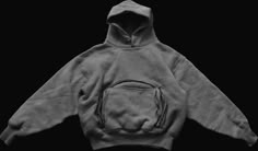 a black and white photo of a hoodie on a black background, with the hood pulled up