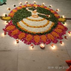 an image of a decorated floor with candles and flowers in the shape of a woman's face