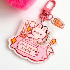 a pink keychain with a cartoon character on it