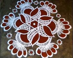 a white and red flower design on the ground