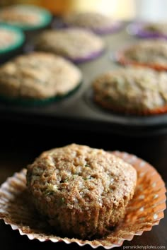 two muffins sitting on top of each other in front of cupcake tins