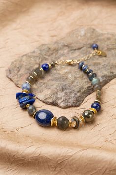 Discover the vibrant and stunning colors of the Blue Moon Collection in this eclectic bracelet! Gold Filled (Lead & Nickel Free) Pyrite, Lapis Lazuli, Sodalite, Abalone, Labradorite, Mother Of Pearl 7.5-8.5" adjustable length, with gold filled lobster claw clasp We hand select our natural materials, thus there may be slight variations in color and/or size that will not detract from the overall aesthetic. Our unique handcrafted designer jewelry for women is made in America, each design created in