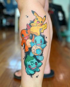 a person's leg with pokemon tattoos on it